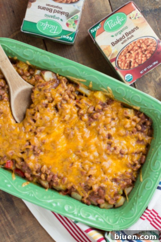 Delicious Loaded Baked Potato and Baked Bean Casserole with melted cheese and crispy bacon