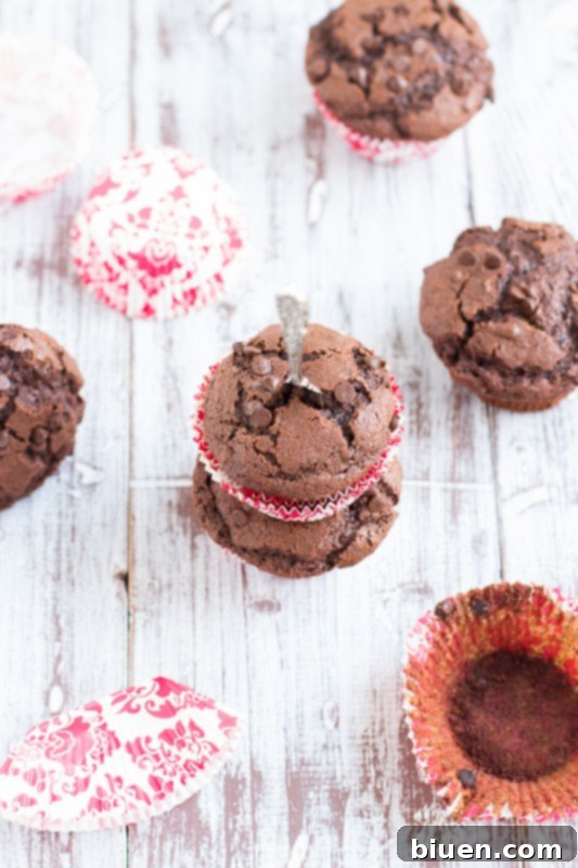 A perfectly baked double chocolate chip muffin on a plate, ready to be eaten
