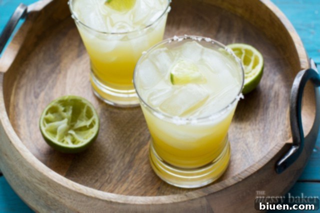 Fresh limes being juiced for a pineapple margarita recipe