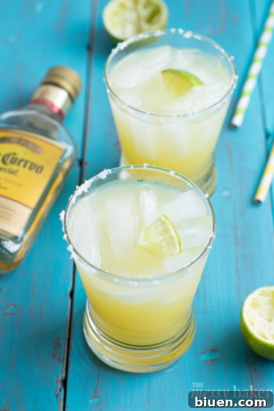 All ingredients for Pineapple Margarita poured into a pitcher, ready to be stirred