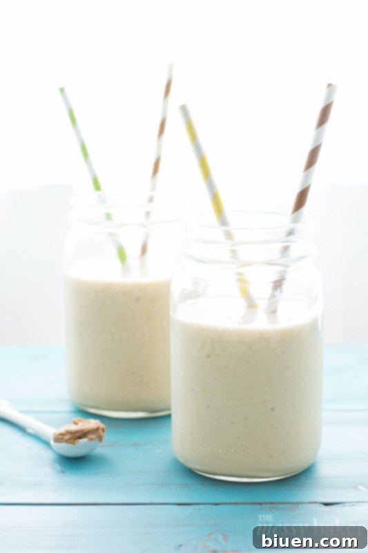 Wholesome PB Banana Oat Boost 5 A close-up shot of the peanut butter banana oat smoothie in a glass, with small bubbles visible, indicating its freshly blended nature.