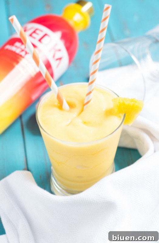 Top-down view of Pineapple Mango Slush Cocktail in a glass