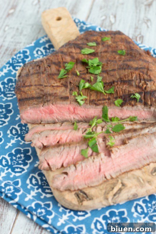 Grilled Tequila Chipotle Flank Steak cooking on the grill.