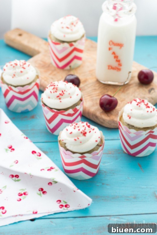 A batch of delicious Cherry Chocolate Chip Cupcakes cooling on a wire rack, promising a delightful treat