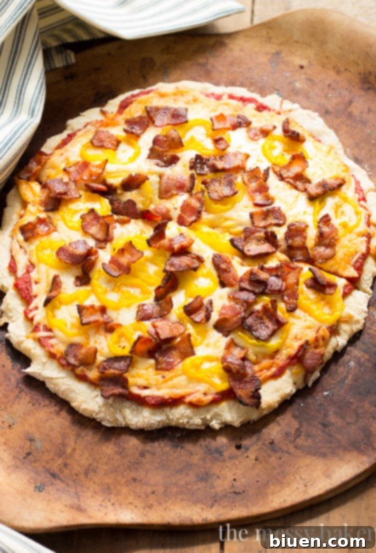 Zesty Gluten-Free Bacon Banana Pepper Pizza 3 Close-up of a slice of Gluten-Free Bacon Banana Pepper Pizza, showing melted cheese and toppings