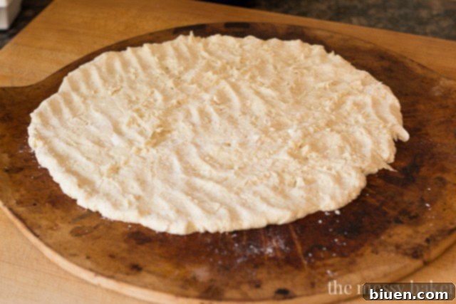 Zesty Gluten-Free Bacon Banana Pepper Pizza 7 Gluten-Free pizza dough being pressed out on a baking sheet