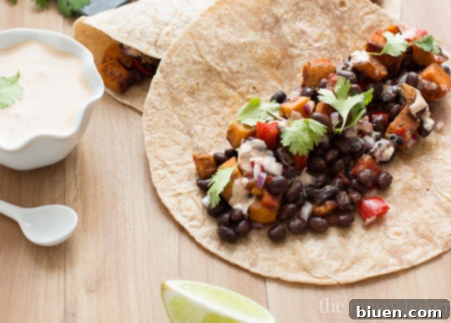 Delicious Sweet Potato and Black Bean Tacos with Chipotle Crema 4 Preparation shot: diced sweet potatoes and red peppers cooking in a pan