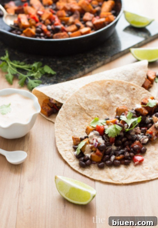 Delicious Sweet Potato and Black Bean Tacos with Chipotle Crema 5 A stack of Sweet Potato & Black Bean Tacos with fresh toppings