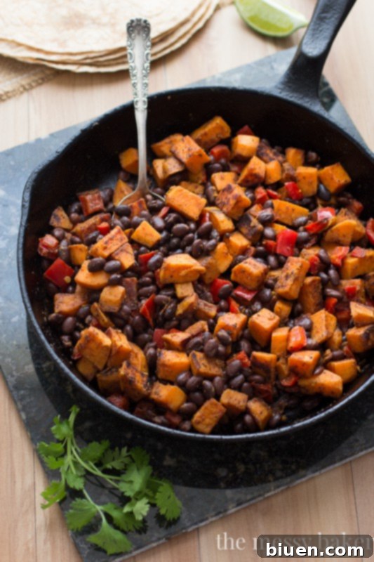 Delicious Sweet Potato and Black Bean Tacos with Chipotle Crema 6 Hand drizzling chipotle crema over a Sweet Potato & Black Bean Taco