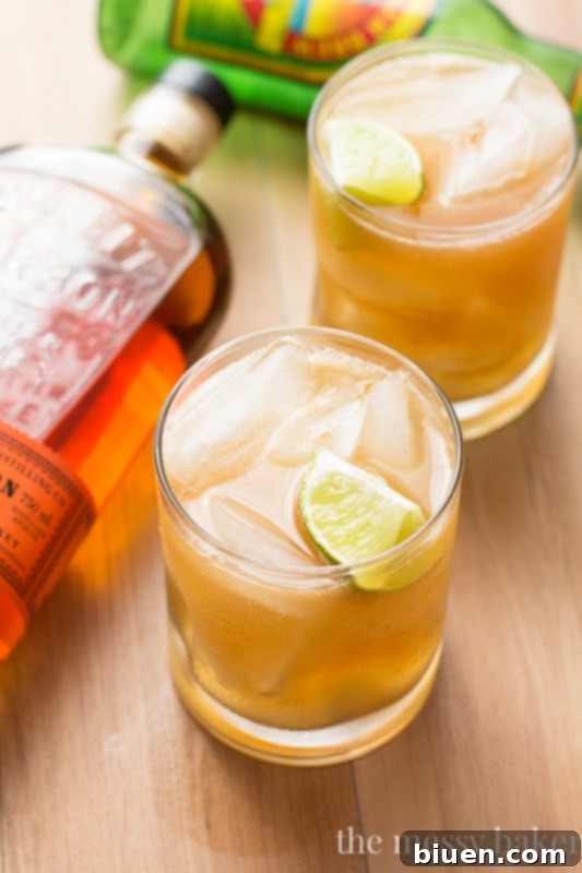Apple Ginger Bourbon Cocktail - A delicious blend of bourbon, apple butter, and ginger beer, garnished with lime, perfect for fall.