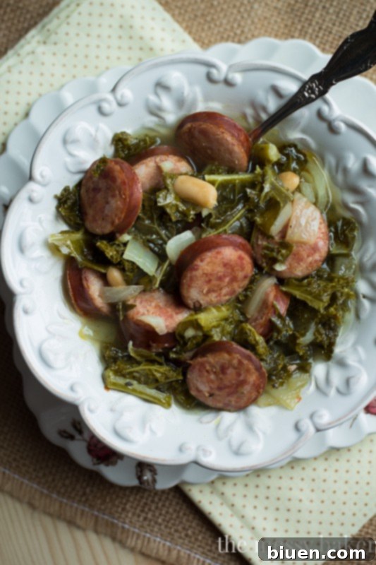 Hearty Slow Cooker Kielbasa, Kale and White Bean Soup 2 Slow Cooker Kielbasa Soup with Kale and White Beans | www.themessybakerblog.com
