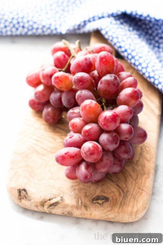 Sweet Grape Ricotta Pound Cake 3 Close-up shot of fresh, vibrant red California Grapes in a rustic bowl, showcasing their plump and juicy appearance, ready for baking or snacking.