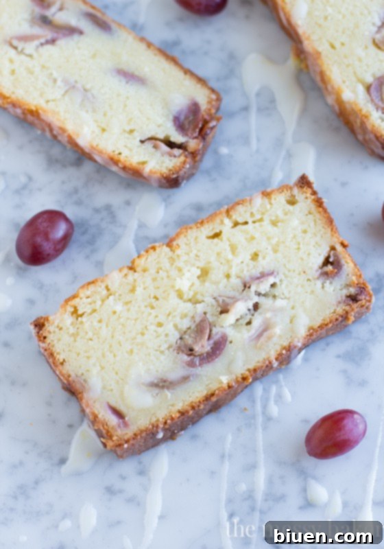 Sweet Grape Ricotta Pound Cake 9 A rustic shot of a golden-brown Ricotta Pound Cake with Grapes and Lemon Glaze, perfectly baked in a loaf pan and ready for slicing, emphasizing its homemade appeal and inviting aroma.