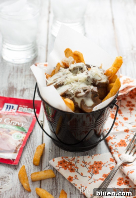 Gluten-Free Mushroom Swiss Poutine | A close-up shot of the poutine, showcasing the melting Swiss cheese and tender mushrooms.
