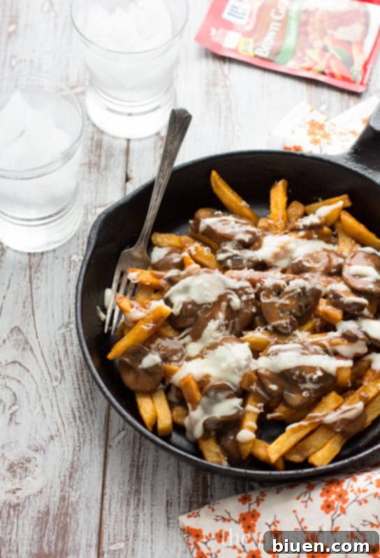 Gluten-Free Mushroom Swiss Poutine | A wider shot of the poutine on a platter, ready for sharing.