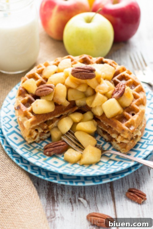 Stack of Gluten-Free Cinnamon Chip Waffles with Caramelized Apples, dripping with sauce