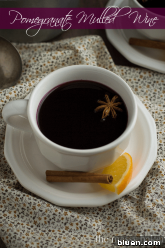 Pomegranate Mulled Wine for Sunday Supper 34 Pomegranate Mulled Wine served in a festive mug, perfect for holiday gatherings