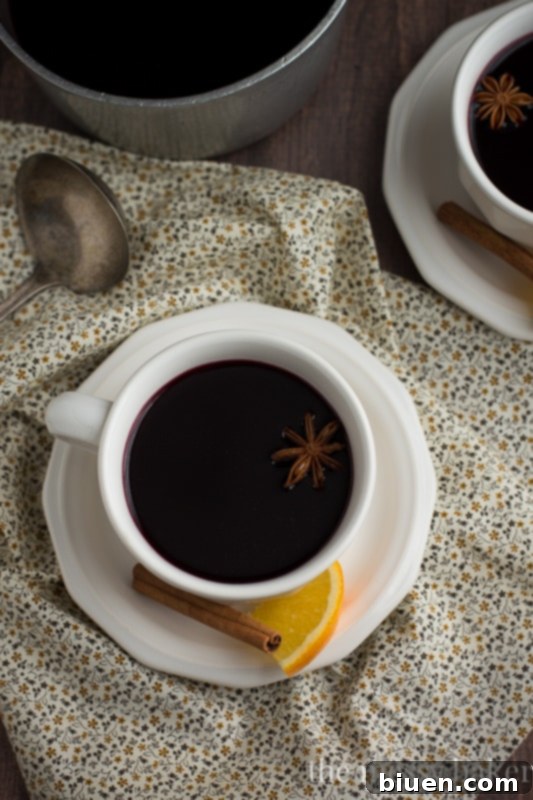 Pomegranate arils, orange slices, and whole spices for mulled wine, beautifully arranged