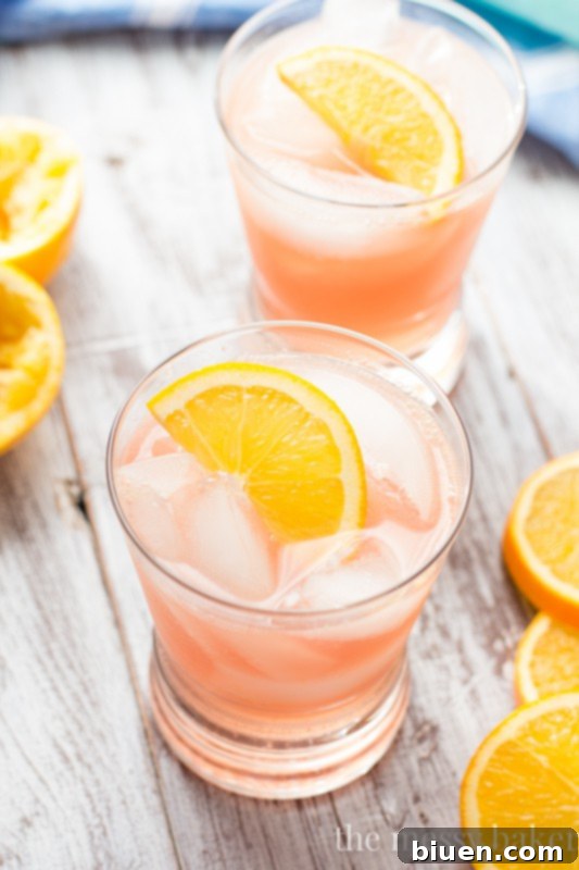 Close-up of a festive Cranberry Orange Crush cocktail with cranberries and orange slices.