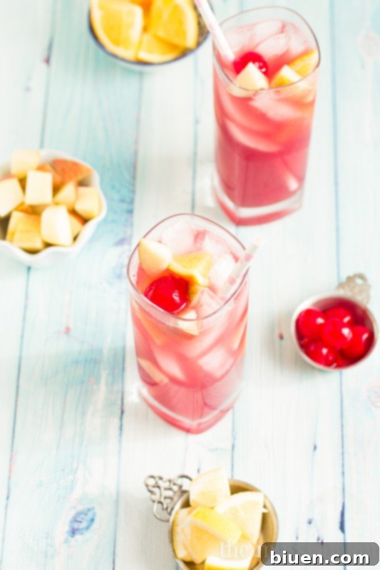 Irresistible Black Cherry Sangria 7 Full pitcher of Black Cherry Sangria with ice and fruit in glasses