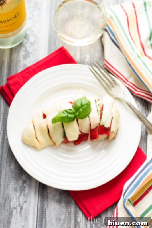 Roasted Red Pepper Caprese Chicken 6 Finished Roasted Red Pepper, Basil, and Mozzarella Chicken with perfectly melted cheese, fresh basil, and roasted red peppers on a plate