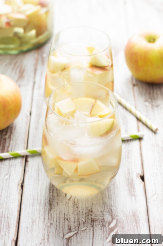 Fizzy Caramel Apple Sangria 5 Pouring Gallo Family Vineyards Apple & Caramel White Wine into a pitcher for sangria