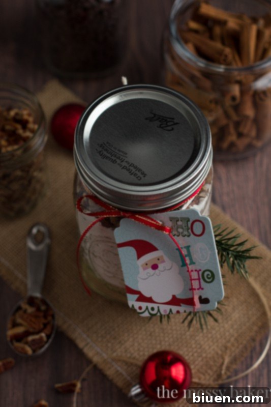 Close-up of Chocolate Chip Pecan Banana Bread Gift Jars, showcasing the beautiful layers of dry ingredients | www.themessybakerblog.com