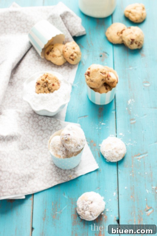 Grandmom's Pecan Sandies | Close-up shot of Pecan Sandies cooling on a wire rack, showcasing their rustic charm before being dusted with powdered sugar.