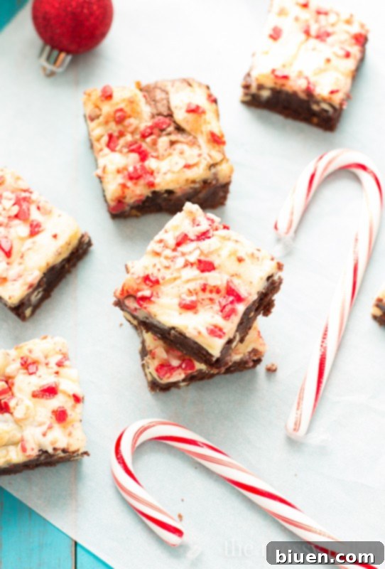 Partially sliced Peppermint Cheesecake Swirl Brownies, highlighting the texture of the brownie layer