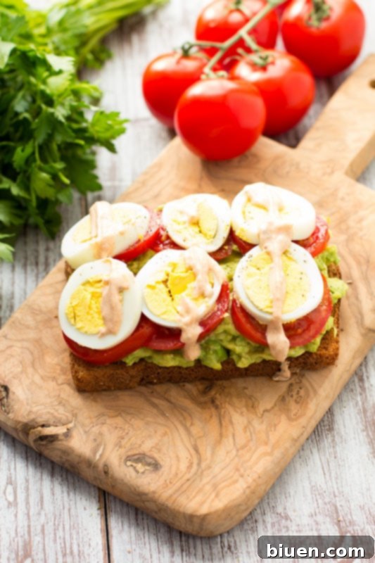 Healthy Avocado, Tomato, and Sliced Egg Toast. This open-faced sandwich is perfect for breakfast or lunch.