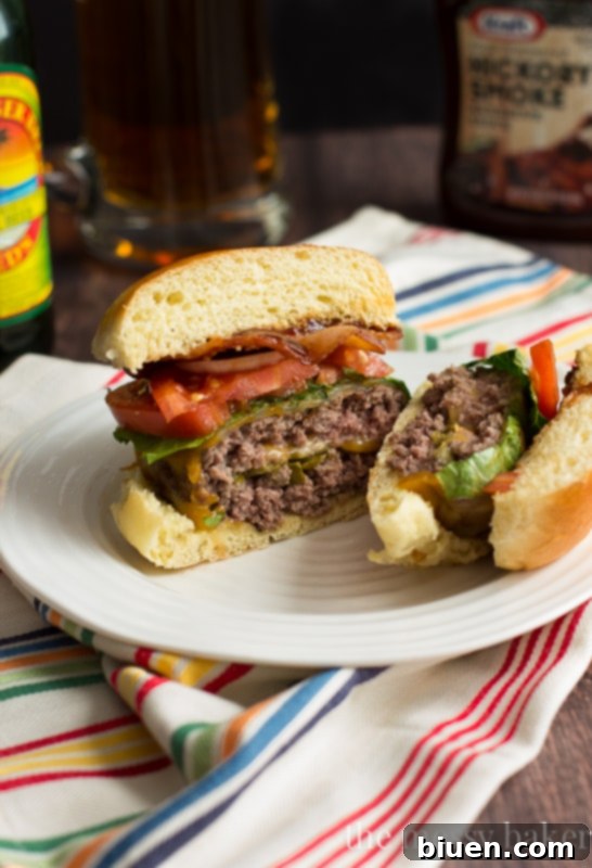 Explosive Jalapeño Popper Bacon Burgers 22 Jalapeño Popper Stuffed Bacon Burgers – a close-up of a stacked burger revealing the juicy patty, melted cheese, bacon, and fresh toppings.