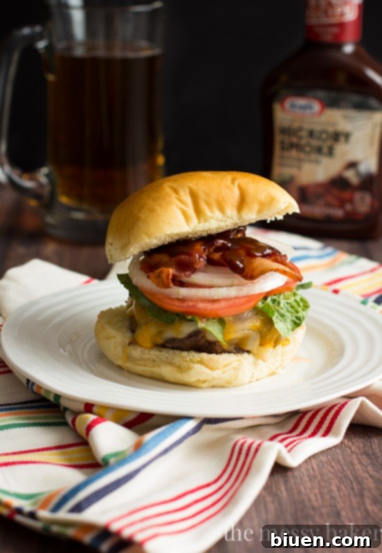 Jalapeño Popper Stuffed Bacon Burgers stacked high with all the toppings, ready to be eaten.