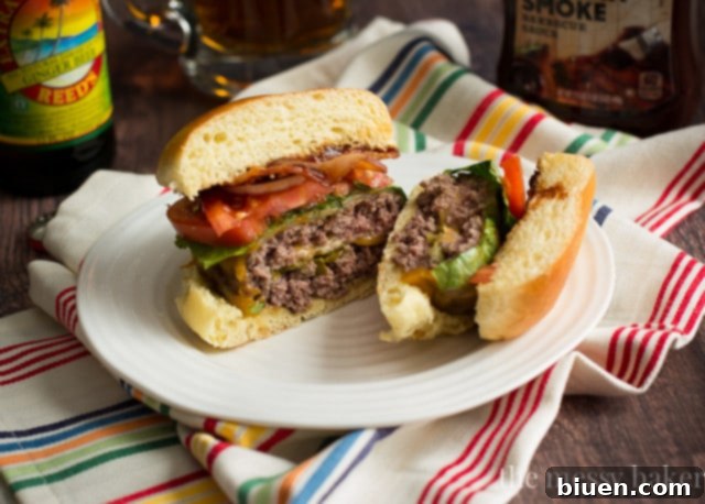 A close-up of a grilled Jalapeño Popper Stuffed Bacon Burger, showcasing the melted cheese and internal filling.