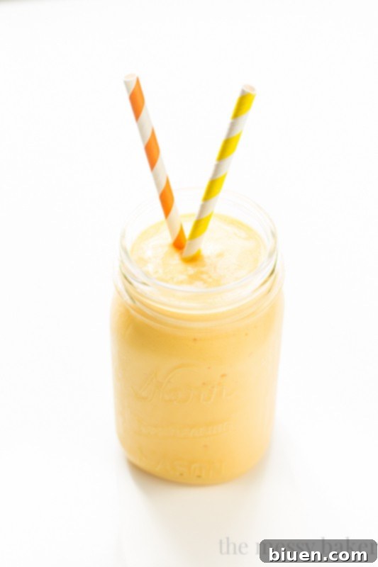 A refreshing Tropical Lassi served in a clear glass