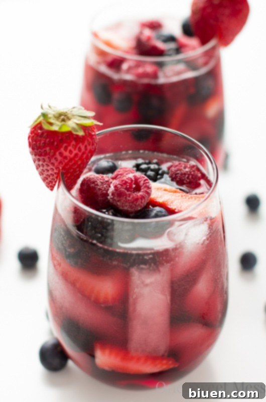 Refreshing Summer Berry Sangria for Sunday Supper 29 Summer Berry Moscato Sangria with fresh berries and wine in a pitcher