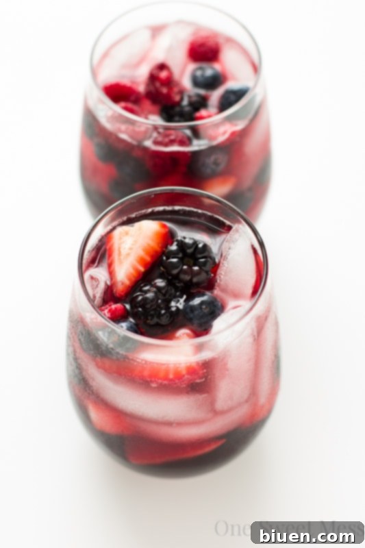 Refreshing Summer Berry Sangria for Sunday Supper 30 Pitcher of Summer Berry Moscato Sangria with berries