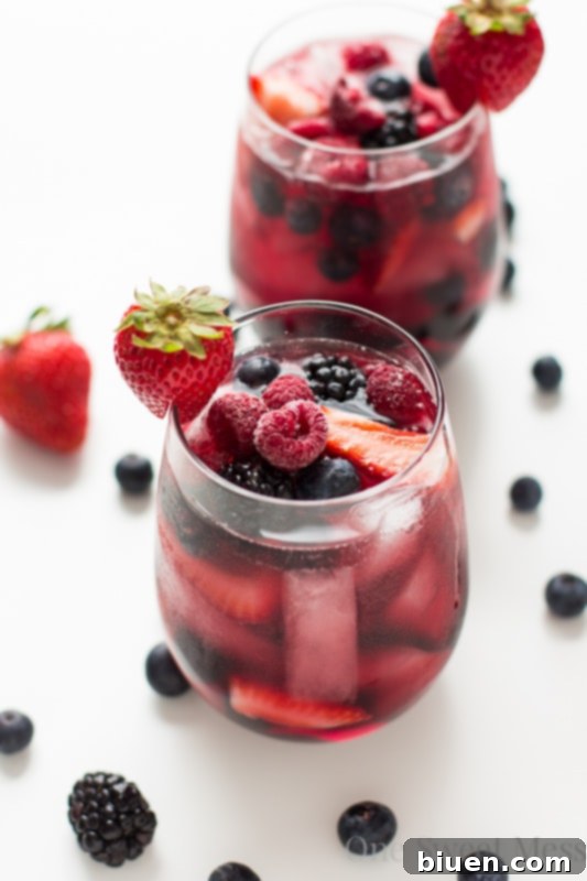 Summer Berry Moscato Sangria glass close-up with fresh berries and mint