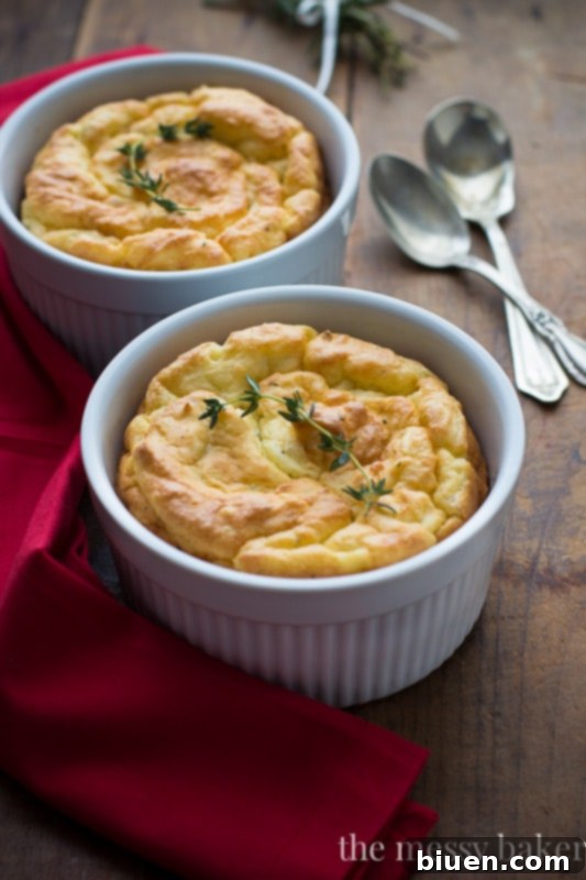 Individual Herb & Cheese Potato Soufflé, perfectly golden and puffed, on a white plate