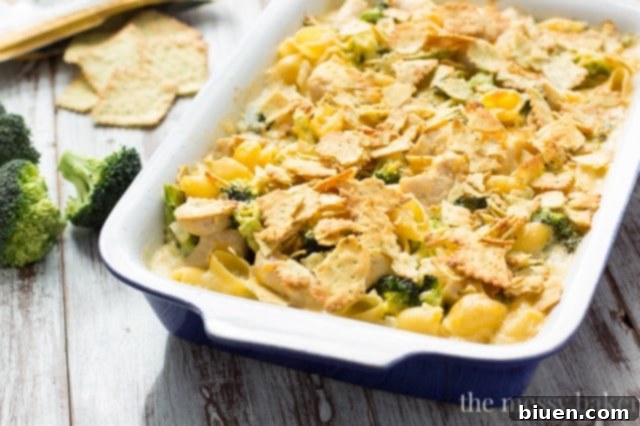 Serving spoon scooping Cheesy Chicken and Broccoli Casserole from a dish