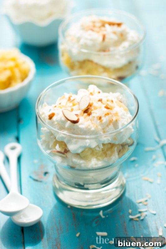 Pina Colada Fool | This no-bake dessert is layered with whipped cream, sweet pineapple, and toasted coconut and almonds. It's ready to serve in 10 minutes. 