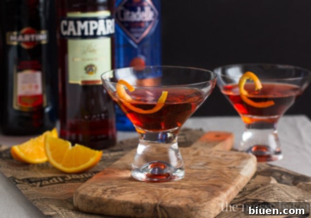 Classic Negroni Cocktail in a rocks glass with a large ice cube.