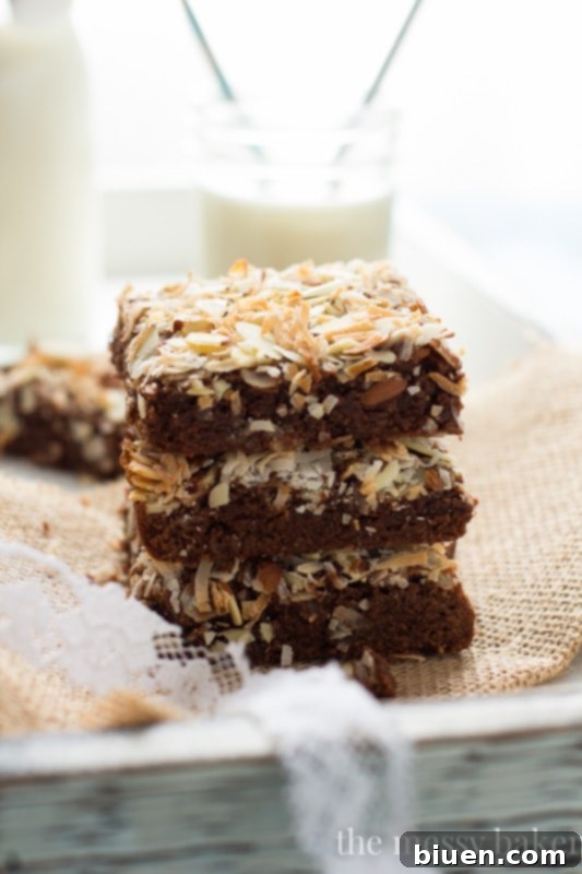 Close-up of a stack of healthy Almond Joy brownies with coconut and almonds