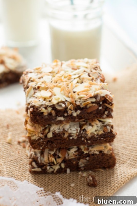 Warm Almond Joy brownies just out of the oven, showing their melted chocolate and toasted topping