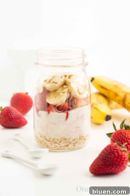 Strawberry Banana Overnight Oats | A creamy mixture of Greek yogurt, vanilla almond milk, fresh fruit, and oats. This healthy breakfast tastes like a decadent dessert.