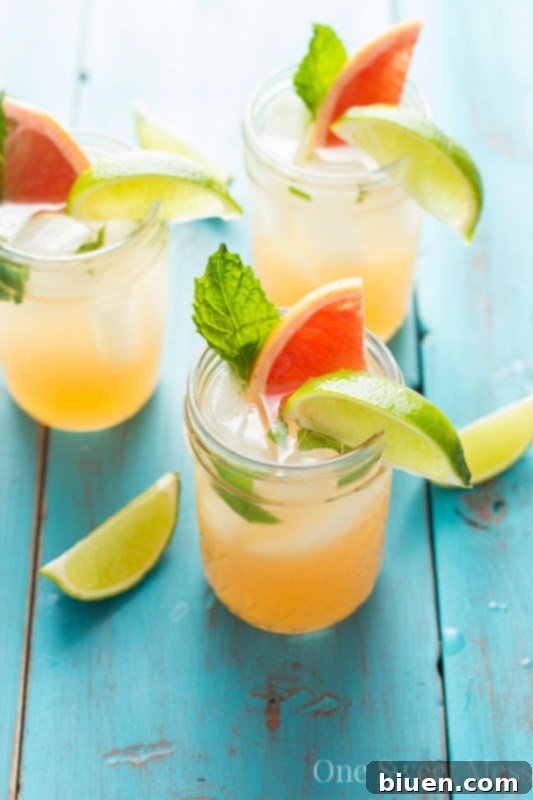 Closeup of a Grapefruit Honey Mojito garnished with mint and grapefruit.