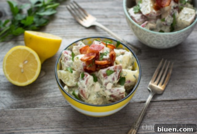 Close-up of creamy Chicken Bacon Ranch Potato Salad with fresh herbs