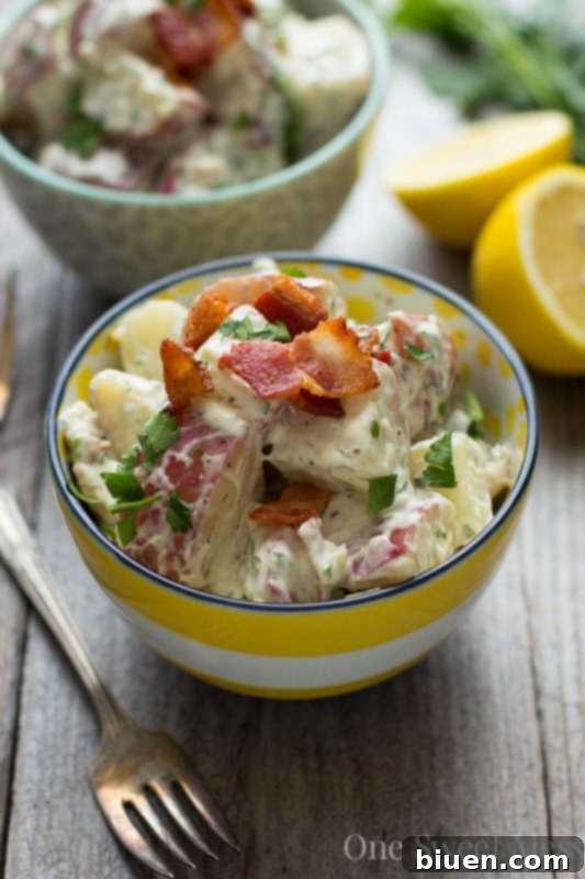 A bowl of Chicken Bacon Ranch Potato Salad, garnished and ready to serve