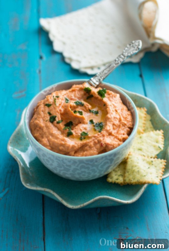 Freshly blended Sun-Dried Tomato & Roasted Red Pepper Hummus in a food processor.