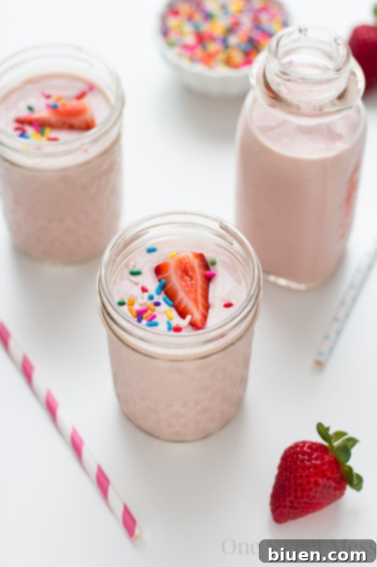 Ingredients laid out for a Strawberry-Banana Cake Batter Smoothie, including funfetti mix and Yulu yogurt