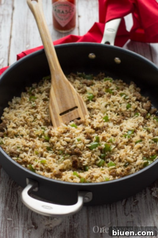 Dirty Rice in a pan with a serving spoon
